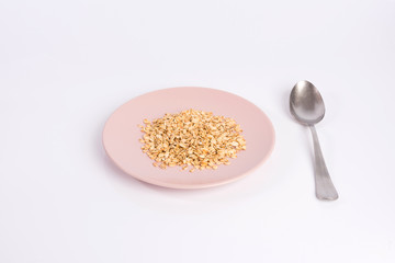 pile of oatmeal on a plate isolated on white background