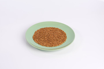 buckwheat groats on a plate isolated on white background