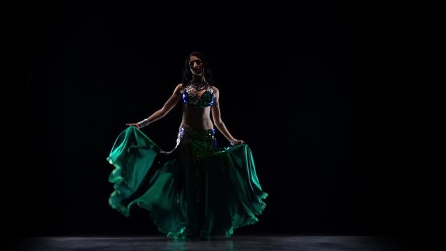 Girl oriental belly dancer. Black background. Slow motion