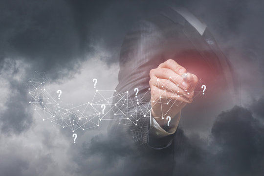 A businessman working with question marks and wireless connection scheme.