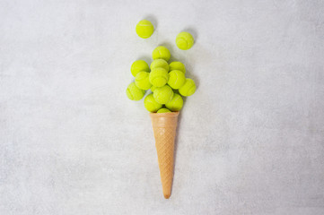 Ice cream cone with tennis ball on white background. Minimal food concept