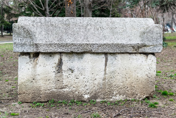 Ancient stone sarcophagus in the park. Antique stone tombs are located in a public park next to the Archaeological Museum in Varna. - obrazy, fototapety, plakaty