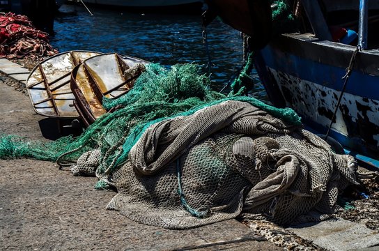 Fishing Net and Fishing Boat Photo - Powered by Adobe