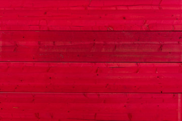 Red painted rough wooden texture surface, horizontal linear pattern.