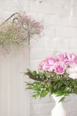 The decor of roses and baby's breath on a white brick wall background
