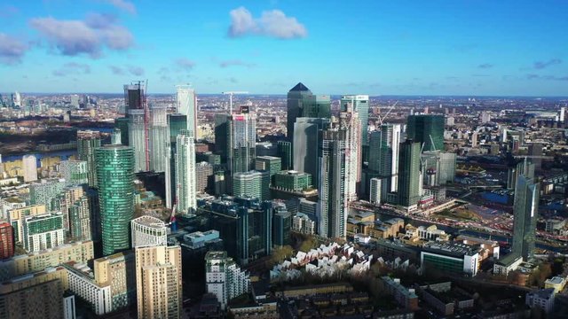 Aerial bird's eye panoramic video taken by drone of iconic Canary Wharf skyscraper complex and business district with beautiful clouds, Isle of Dogs, London, United Kingdom