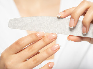 Fototapeta premium Woman gets manicure procedure in a spa salon. Beautiful female hands.