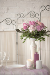 The decor of roses and baby's breath on a white brick wall background