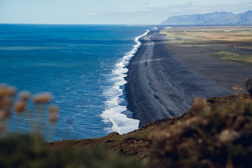 View of the beach near the cape Dyrholaey at the village of Vik in Iceland