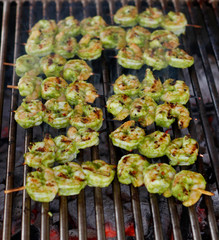spice marinated prawns skewers on a charcol grill