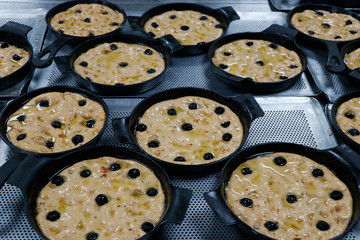 focaccia bread dough portions in a metal baking plate