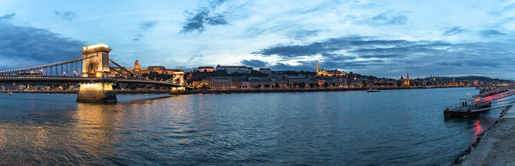 Fototapeta na wymiar Panoramic sunset view of the Buda shore with Buda Castle, Chain Bridge and Fishermen's Bastion, Budapest, Hungary
