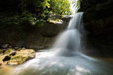Naklejka na ściany i meble A valley with a waterfall . Russian nature near Sochi, Caucasus Mountains.