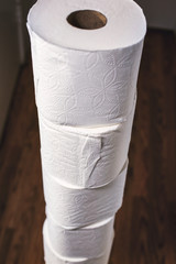 A tower of toilet paper in the hallway