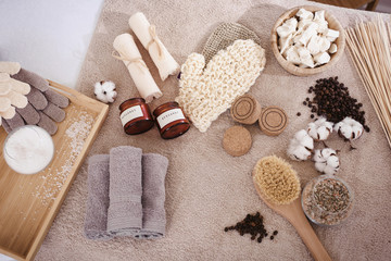 Top view spa and wellness setting with natural bath salt, soap, candles, towels, cotton flowers and coffee beans for massage for perfect healthy body and skin. Beauty luxury spa concept. Copyspace