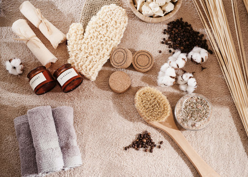 Top view spa and wellness setting with natural bath salt, soap, candles, towels, cotton flowers and coffee beans for massage for perfect healthy body and skin. Beauty luxury spa concept. Copyspace