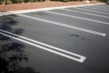 Several empty parking stalls with white painted markings