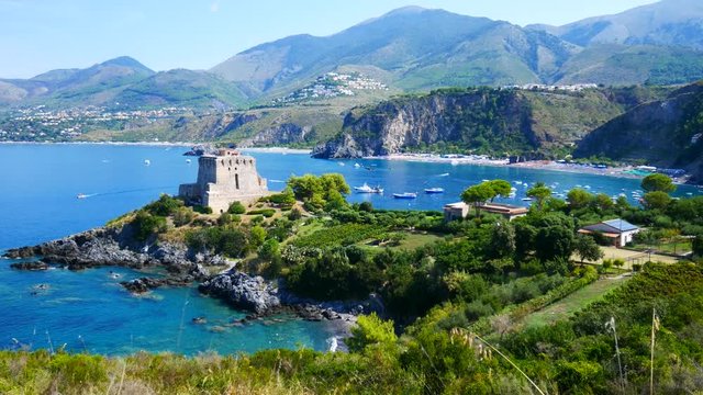 San Nicola Arcella, Calabria, Italy - September 6 2018: Dino island, Crawford tower (watchtower) and boats on Mediterranean sea (Tyrrhenian)