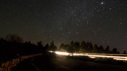 Grand Canyon National Park from the South Rim - at night surrounded by tons of stars with...