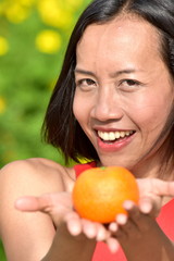 Youthful Diverse Female Smiling With Fruit