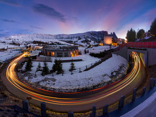 Beautiful modern hotel complex framed by street light trails in Seiser Alm, Italy