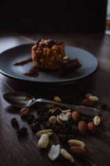 Anthill cake with chocolate and coffee on a dark background. Dessert with nuts and raisins. Bolo formigueiro. Russian funnel cake recipe.