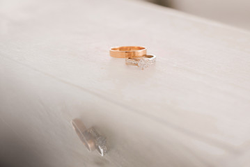Wedding rings. Simple male ring and ring for a woman with a diamond. Close-up.