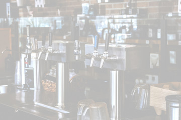 A restaurant background featuring barista cold brew taps at a cafe