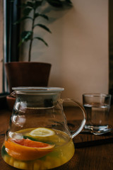 Ginger tea with mint and lemon and grapefruit. Herbal healthy drink in the teapot in local cafe