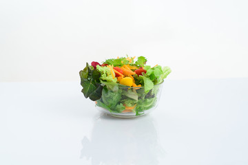 Mix of vegetable salad in glass bowl