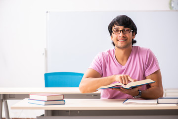 Young male student sitting in the class