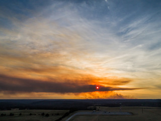 Aerial sunset with a large brush fire