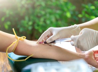 Nurse collecting a sample blood from a patient