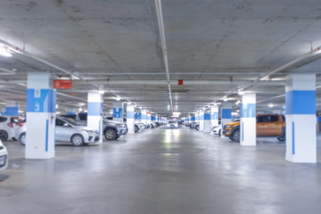 Blurred parking image,Parking in interior shot of multi-story car park, underground parking with cars.
