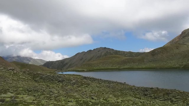 Timelapse lake scene in mountains, national park of Dombay, Caucasus, Russia. Summer landscape, sunshine weather, blue sky and sunny day