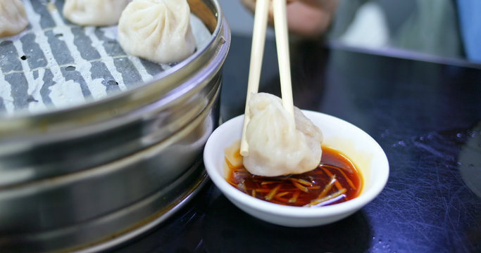Chinese steamed meat dumpling with sour ginger sauce