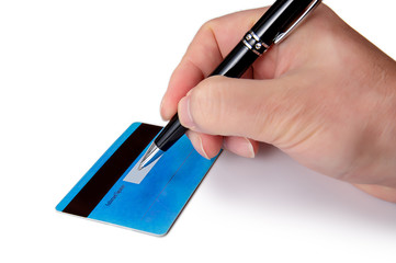 Businessman's hand signing the back of his credit card.