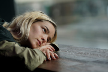 Fototapeta premium Woman absorbed in thoughts looking out the window