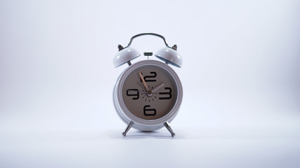 Ringing metal alarm clock isolated on white background.