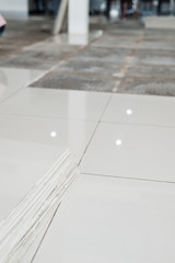 Ceramic tiles and tools for tiler. Floor tiles installation. Home improvement, renovation