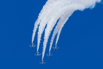 white smoke lines in blue sky