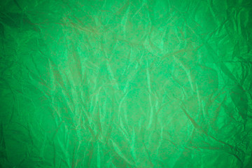 Crumpled green paper recycling background.