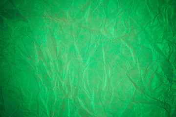 Obraz na płótnie Canvas Crumpled green paper recycling background.