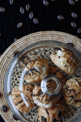 Cake profiteroles with butter cream and chocolate against a dark background. Soft focus.