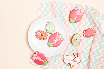 Easter homemade gingerbread cookies on the plate on a light background with a napkin.