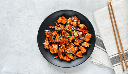 teriyaki chicken's  with  sesame seeds. spicy chicken in sweet and sour sauce with chili pepper. Chinese cuisine, copy space, recipe background, food flat lay, menu of japanese restaurant