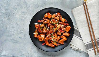 teriyaki chicken's  with  sesame seeds. spicy chicken in sweet and sour sauce with chili pepper. Chinese cuisine, copy space, recipe background, food flat lay, menu of japanese restaurant