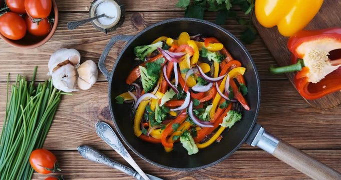 Cinemagraph - Cooking vegetables in a frying pan. Top view. Motion Photo. 