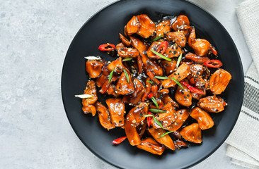 teriyaki chicken's  with  sesame seeds. spicy chicken in sweet and sour sauce with chili pepper. Chinese cuisine, copy space, recipe background, food flat lay, menu of japanese restaurant