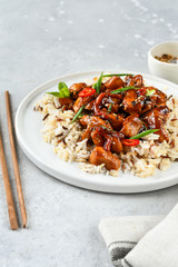 teriyaki chicken's  with chili pepper and sesame seeds, with rice. on a white plate, copy space, selective focus, Asian cuisine, Chinese cuisine,  food flat lay. light background, recipe background